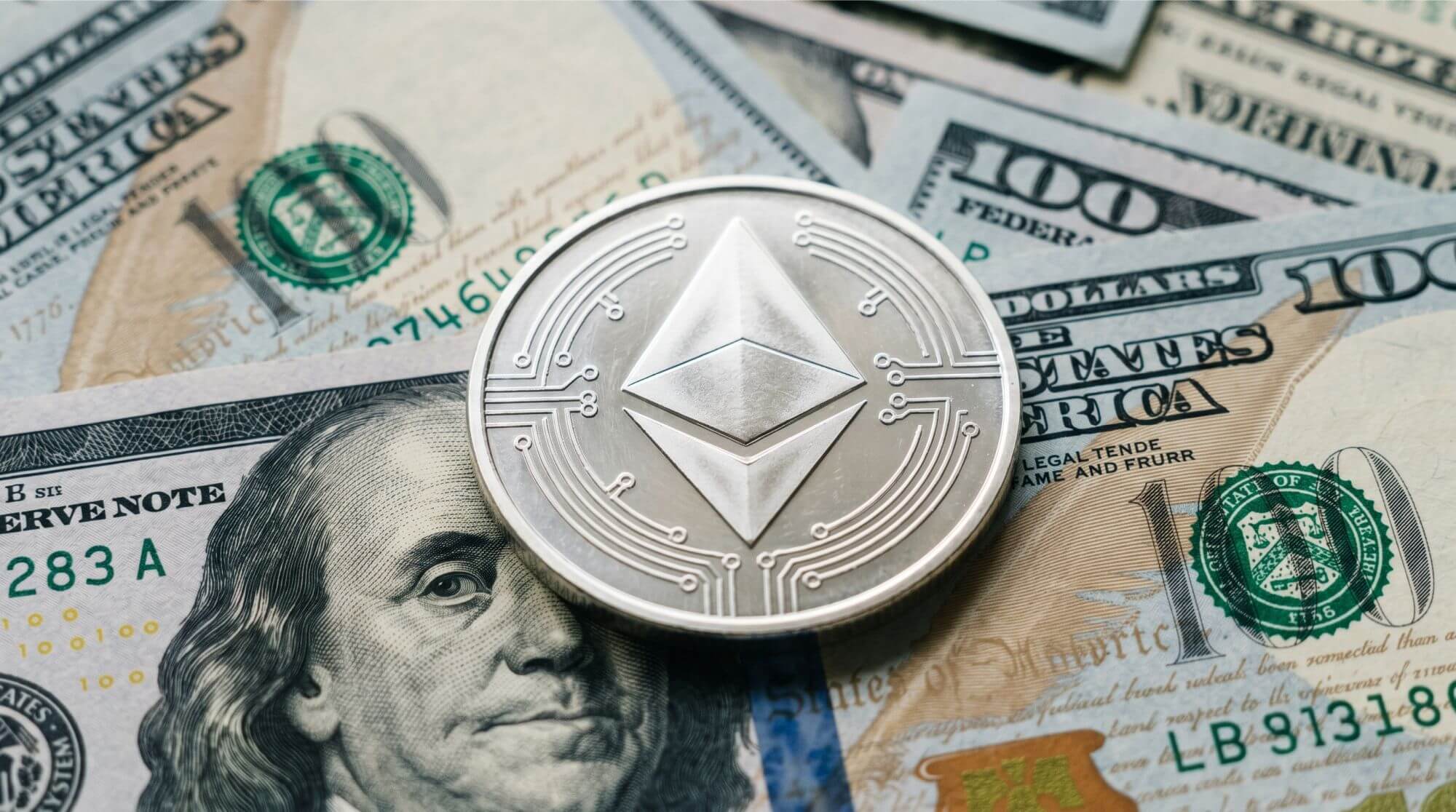 Imagen de una moneda de Ethereum sobre billetes de dólar