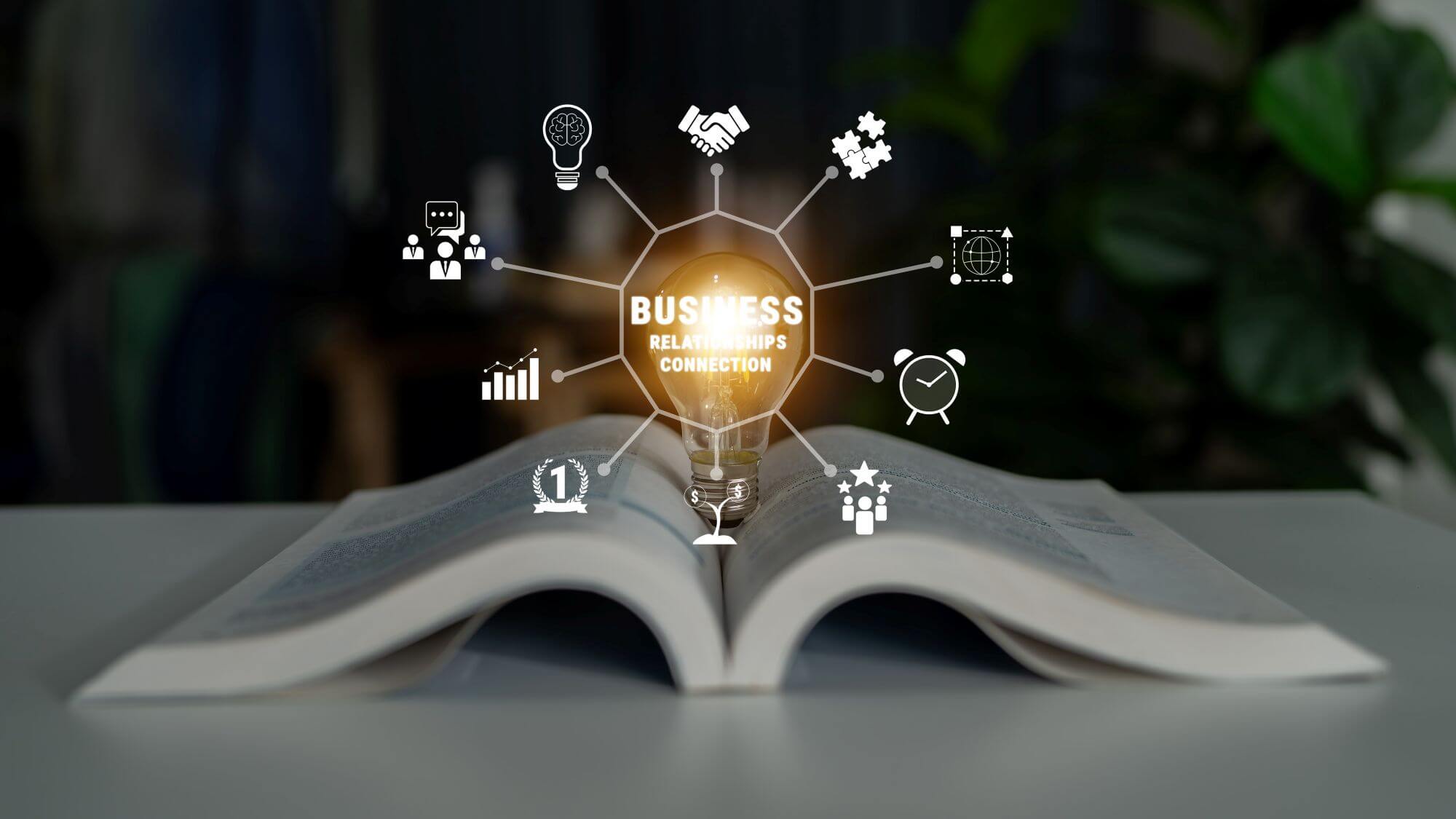 Imagen de un libro abierto sobre el que se lee 'Business Relationships Connection' en un artículo sobre libros para aprender a invertir